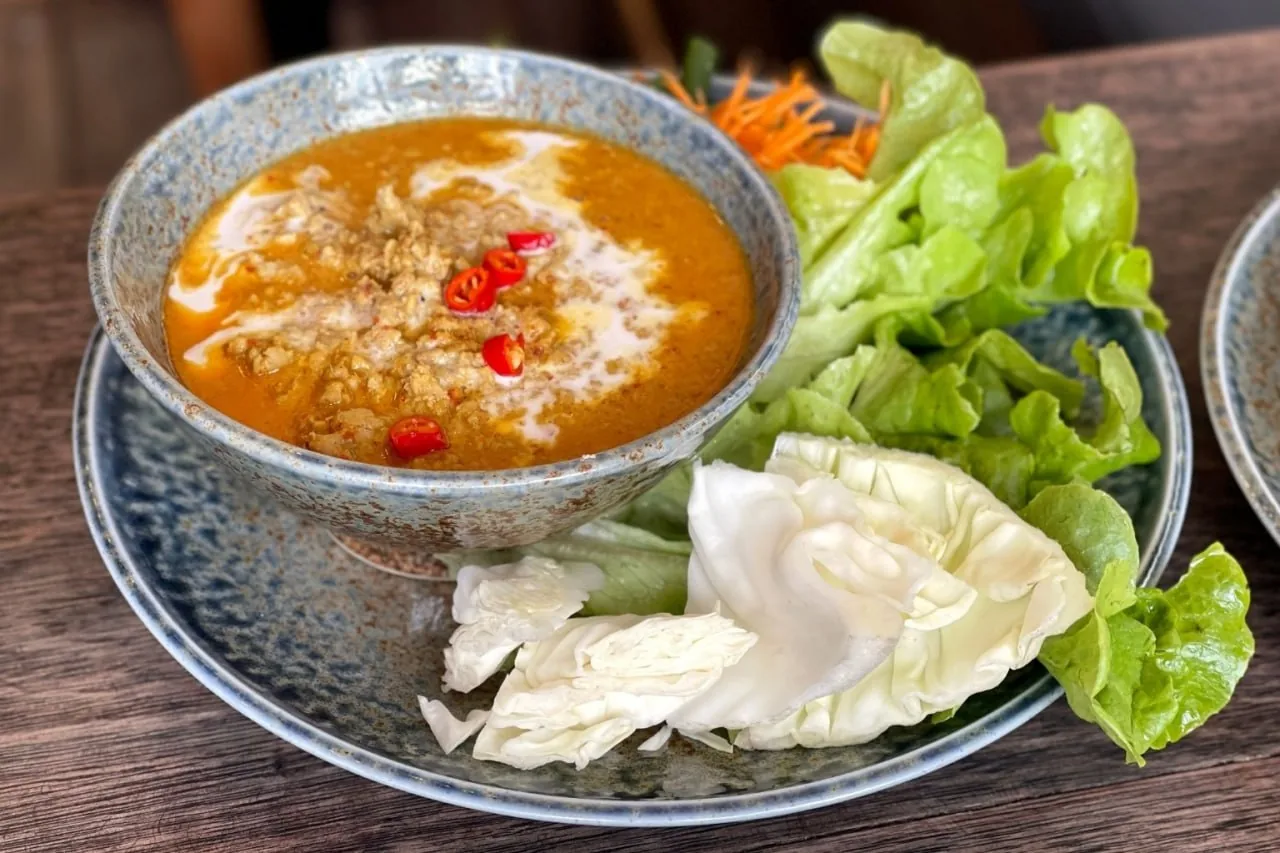 Prahok ktis — fermented fish paste cooked down with minced pork and coconut milk, served with raw vegetables