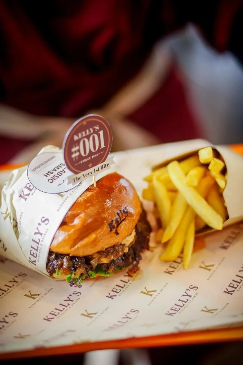 Kelly's Kitchen, Sen Sok — a classic smash with fries, wrapped in the house paper